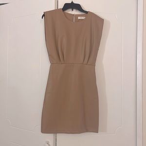 Vegan leather minidress with front tuck details and side zip for easy styling.